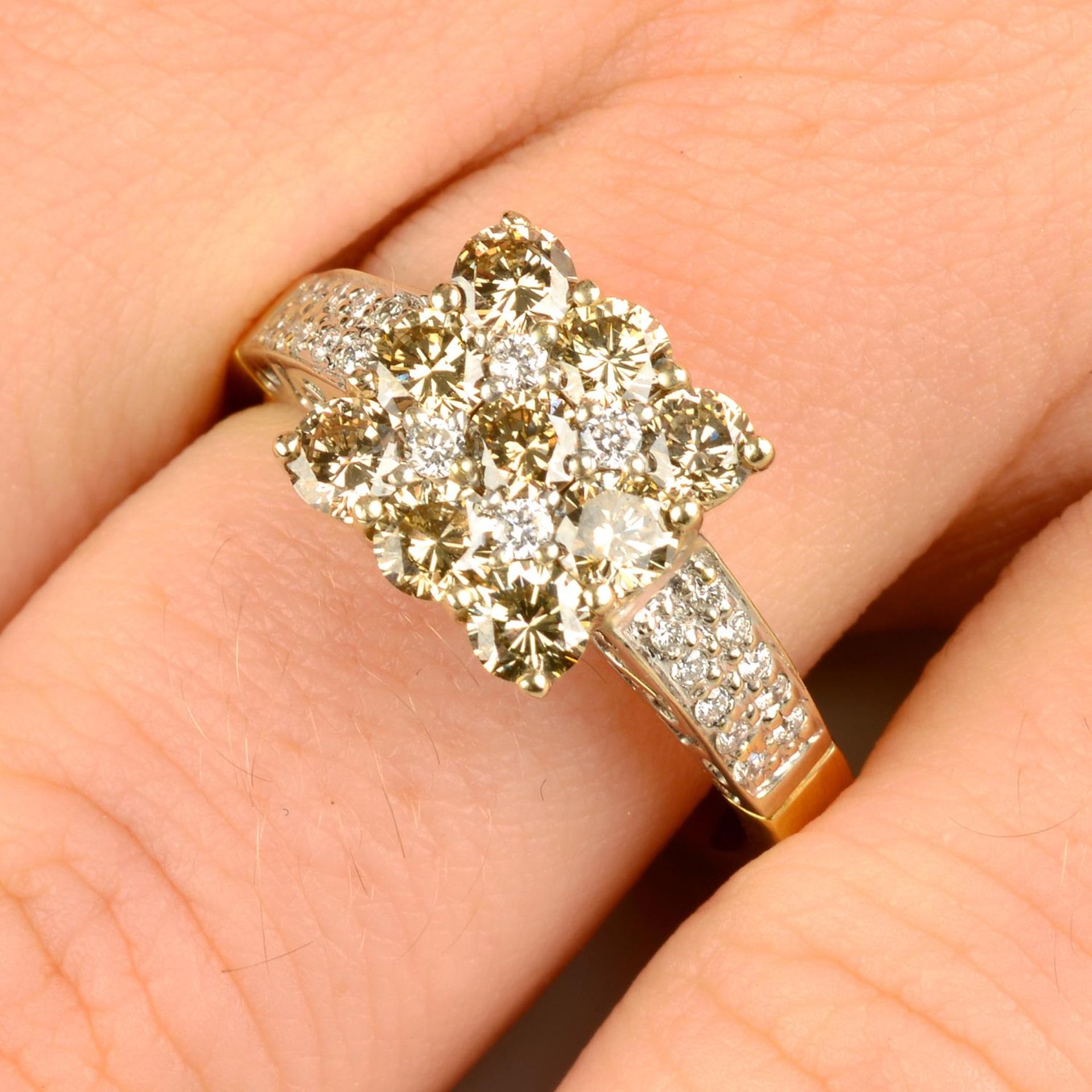 A 'brown' diamond and diamond cluster ring, with pavé-set diamond shoulders.