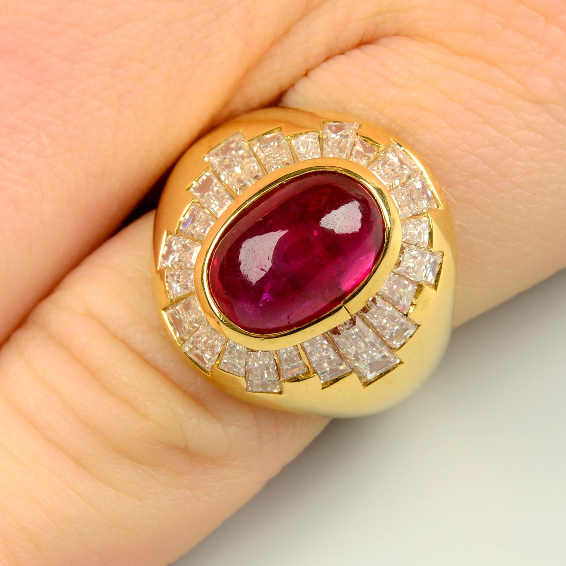 A ruby cabochon and baguette-cut diamond cluster ring.