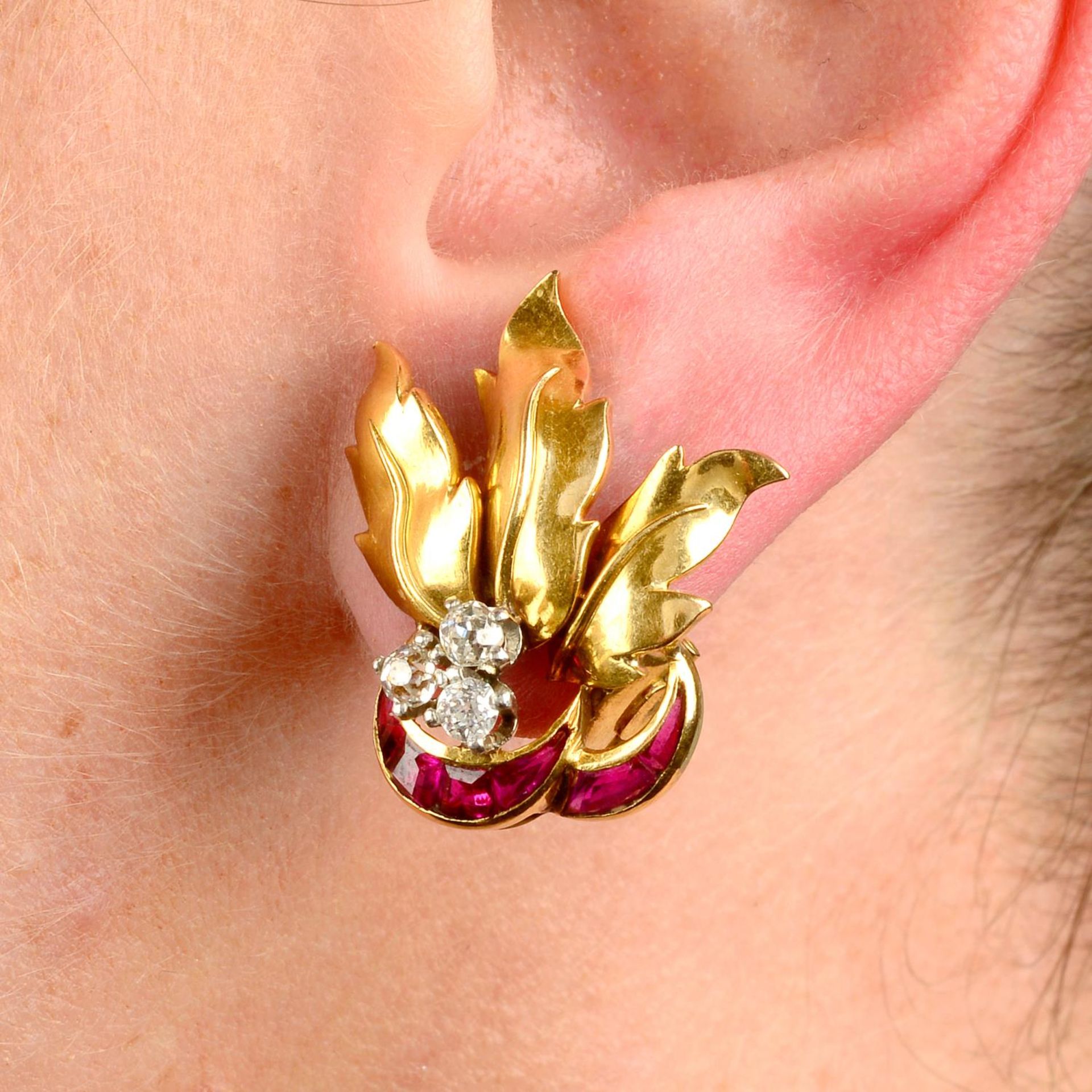 A pair of 1940s 18ct gold calibré-cut ruby and old-cut diamond foliate earrings.Estimated total