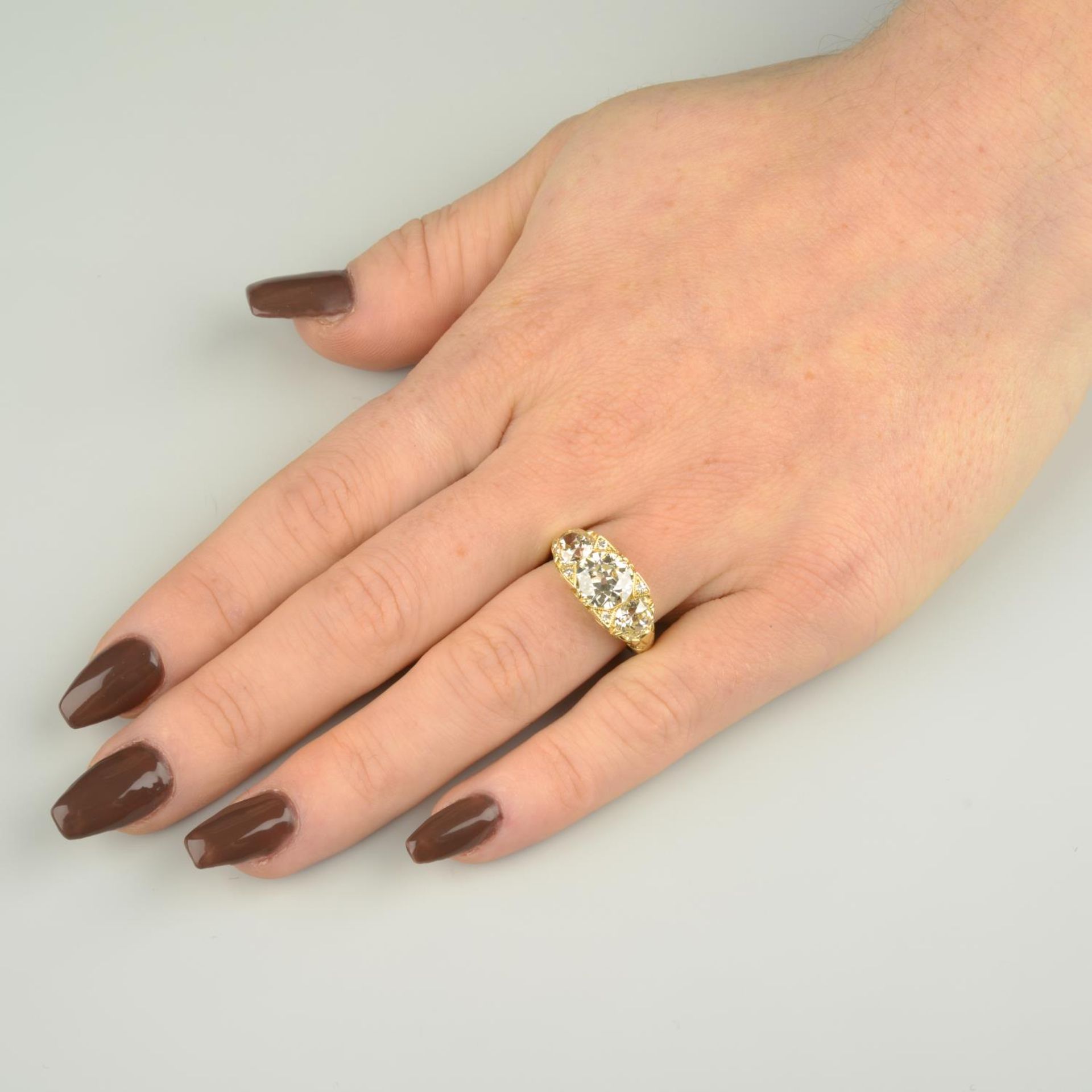 A graduated old-cut diamond three-stone ring, with single-cut diamond accents. - Image 4 of 7