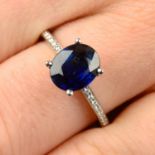 A sapphire single-stone ring, with diamond line shoulders.