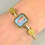 A late 19th century 15ct gold hinged bangle with enamel panel depicting Eros and Psyche and