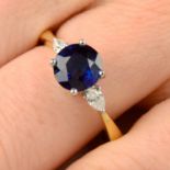 A sapphire and diamond three-stone ring.