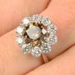 An 18ct gold brilliant-cut 'brown' diamond and brilliant-cut diamond cluster ring.Principal diamond