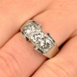 A mid 20th century platinum circular-cut diamond three-stone ring,