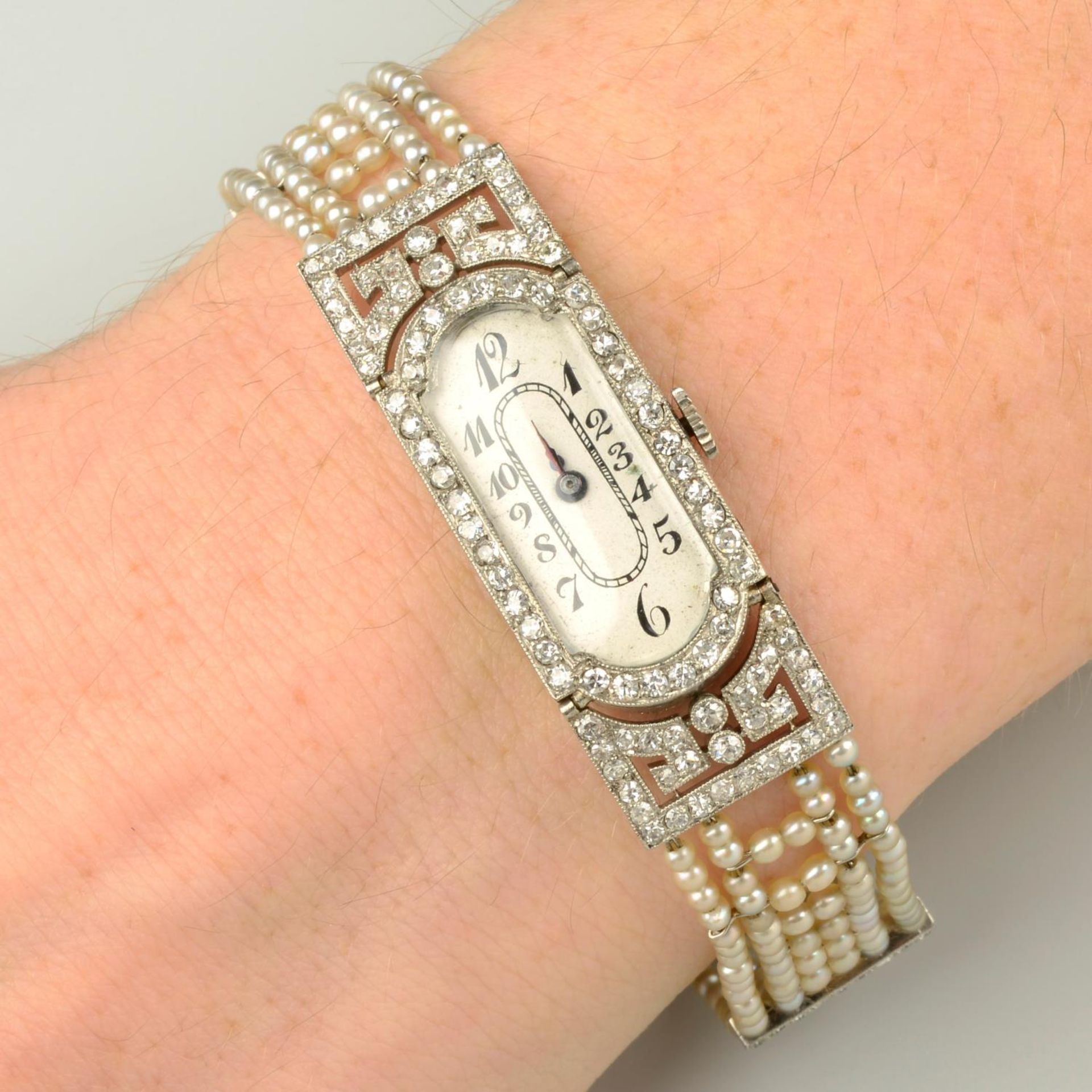 A lady's Art Deco platinum and 18ct gold diamond wristwatch, with seed pearl and diamond strap.
