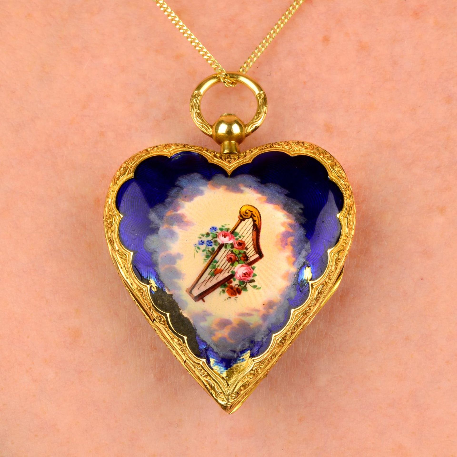 A late Victorian 18ct gold heart-shape fob watch, with enamel Christian iconography.Length 4.2cms.