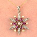 An early 20th century platinum and gold, ruby, seed pearl and diamond floral pendant.