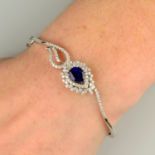 A sapphire and brilliant-cut diamond peacock tail feather hinged bangle.Estimated total diamond