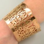 An openwork cuff bangle, with floral motif.