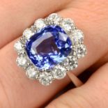 An 18ct gold sapphire and brilliant-cut diamond cluster ring.Sapphire weight 5.72cts.Total diamond