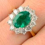 An 18ct gold emerald and brilliant-cut diamond cluster ring.Emerald weight 2.43cts.Total diamond