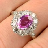 A pink sapphire and diamond cluster ring.