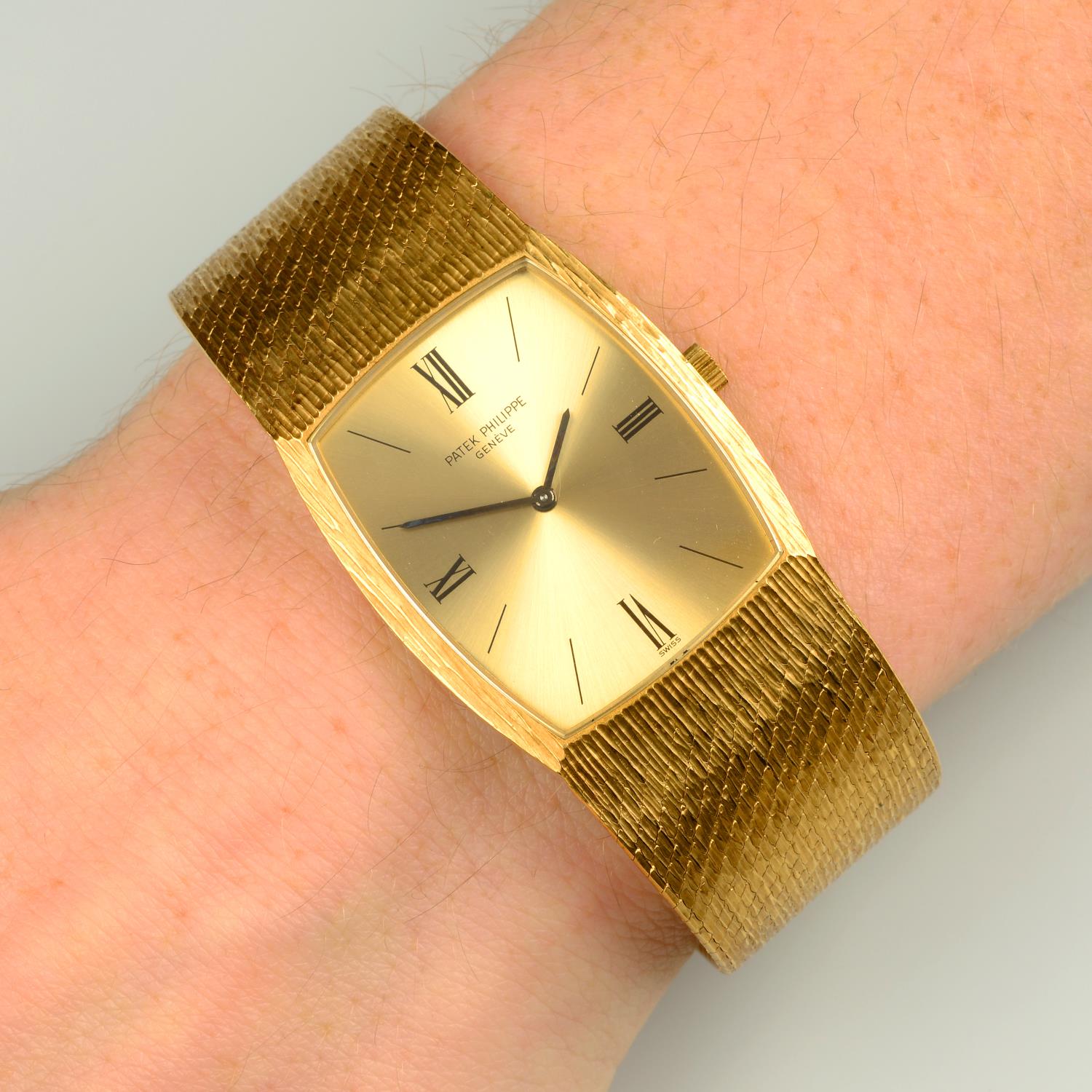 A gentleman's 1970s 18ct gold textured wristwatch,