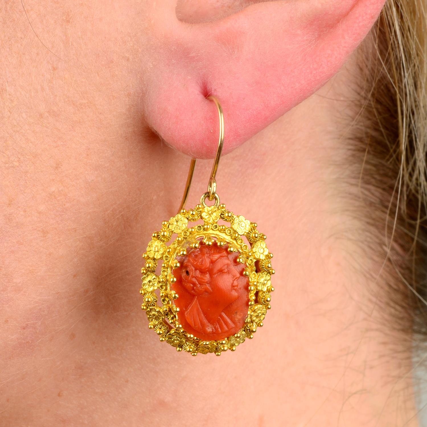 A pair of mid to late 19th century gold coral cameo earrings.Length 3.4cms.