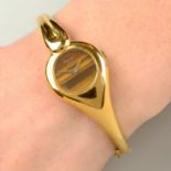 A 1970s 18ct gold bangle watch,