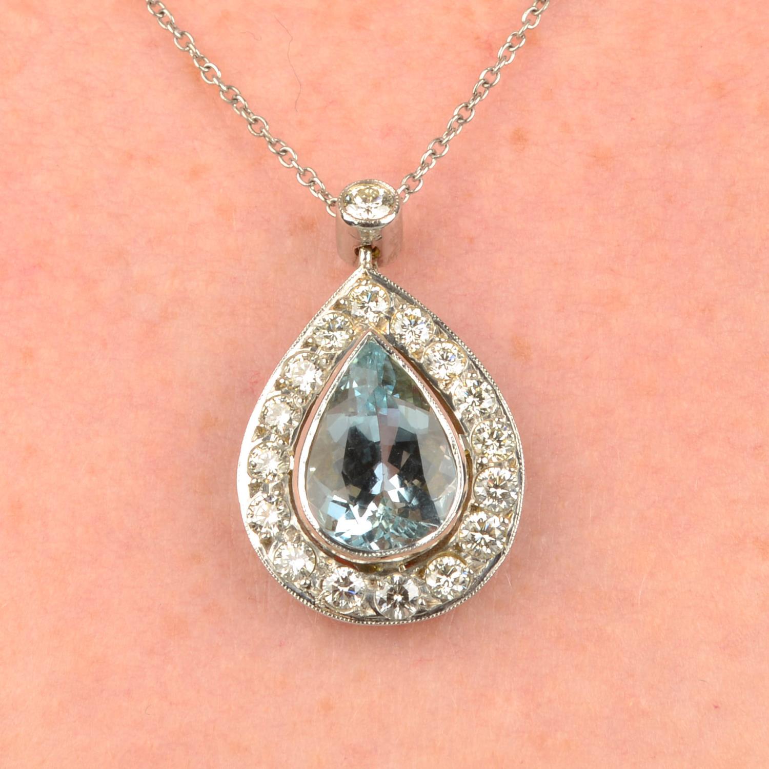 An aquamarine and diamond cluster pendant, on chain.