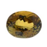 An oval-shape brownish-orange tourmaline.