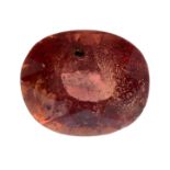 An oval-shape orange sapphire.