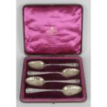 A cased set of four George III silver 'berry' spoons,