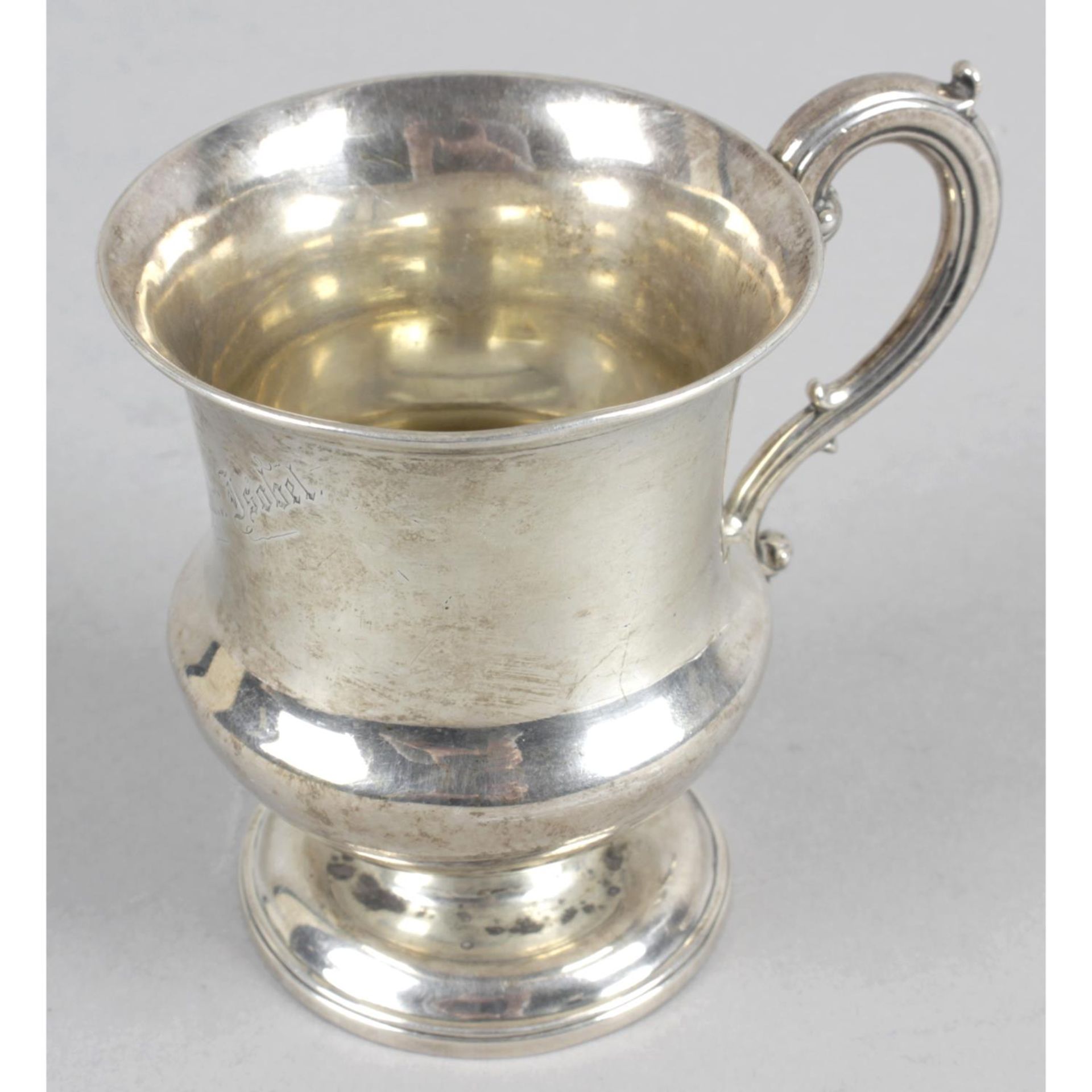 A Georgian silver christening mug of urn shape with acanthus scrolling handle.