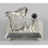 A modern silver novelty desk pen holder,