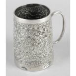 An ornately chased christening cup,