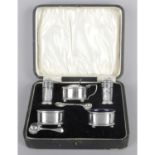 A cased silver condiment set,