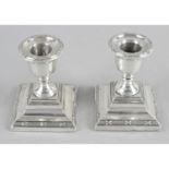 A pair of George V silver mounted dwarf candlesticks,