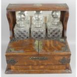 An early 20th century oak tantalus,