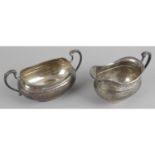 A matched 1930s silver twin-handled sugar bowl and cream jug,