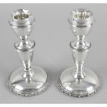 A pair of small silver candlesticks,