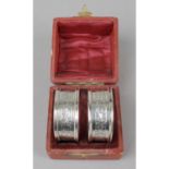 A cased pair of late Victorian silver napkin rings,