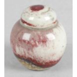 A Ruskin pottery sang-de-boeuf high temperature fired and glazed miniature ginger jar and cover.