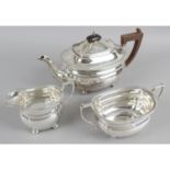 A mid-20th century silver three piece tea set of plain ovoid bulbous shape standing on squat bun