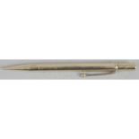 A 9ct gold cased propelling pencil, the plain tapered cylindrical case with impressed marks .375.