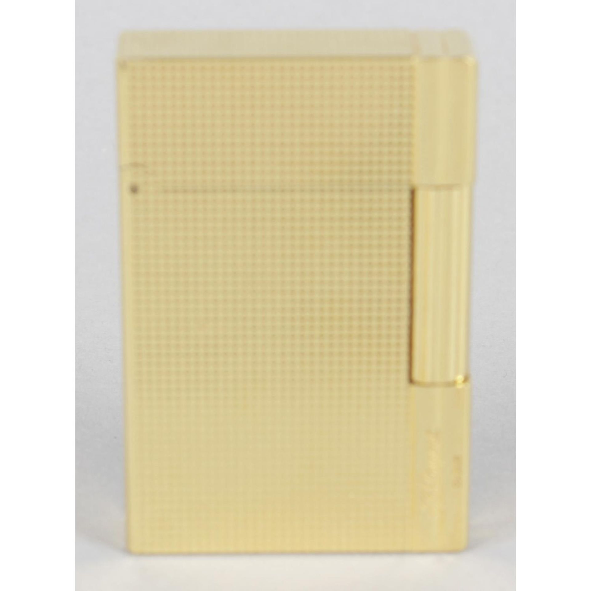 A cased S. T. Dupont gold plated lighter,