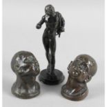 A small pair of cast bronze busts, each modelled as an African male, height 2.5 (6.5cm).