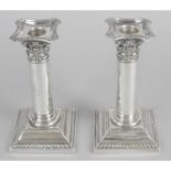 A pair of late Victorian small silver candlesticks,