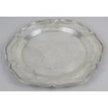 A circular salver, the plain centre leading to a scalloped edge with gadrooned rim.