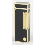 A Dunhill rollergas gold plated lighter, with black lacquer body.