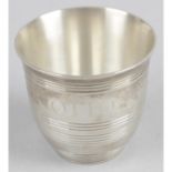 A small silver shot cup,