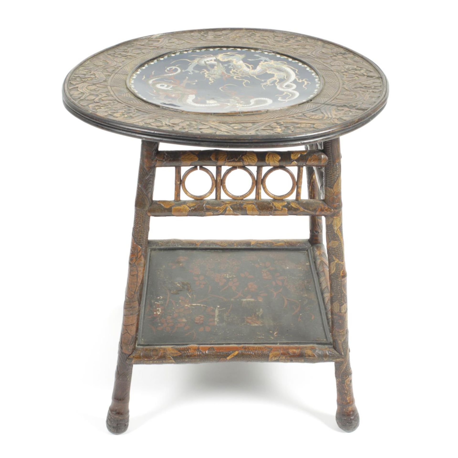 An early 20th century Oriental carved wooden and bamboo two tier occasional table,