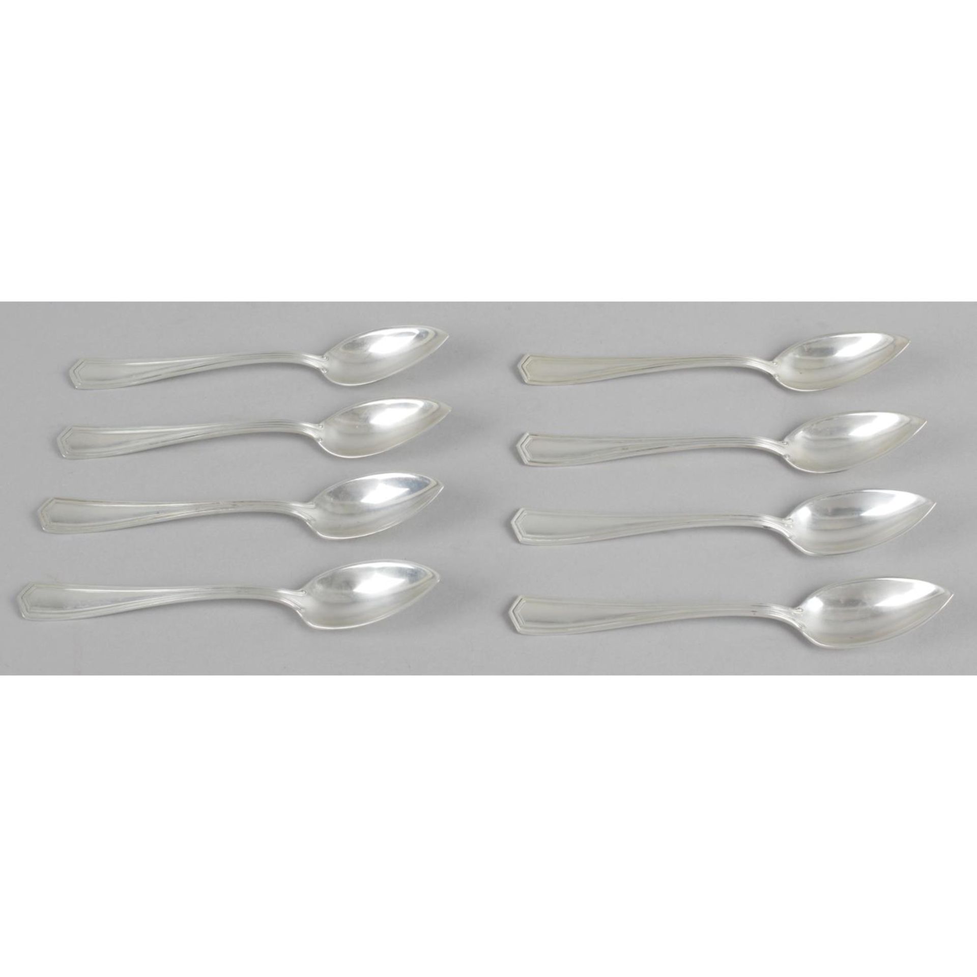 A set of eight American silver grapefruit spoons, with the bowl leading to a pointed tip.
