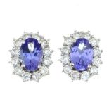 A pair of 18ct gold tanzanite and diamond cluster stud earrings.Estimated total diamond weight