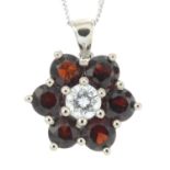 A garnet and diamond floral cluster pendant, suspended from an 18ct gold chain.