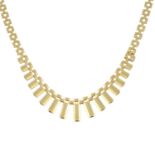 A 9ct gold fringe necklace, with brick-link sides.Hallmarks for 9ct gold.