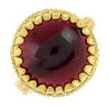 A garnet single-stone ring.Stamped 18K.Ring size approximately M.