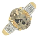 An 18ct gold zircon and diamond ring.Estimated total diamond weight 0.15ct.