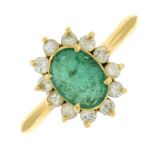 An emerald and diamond cluster ring.Estimated total diamond weight 0.35ct.
